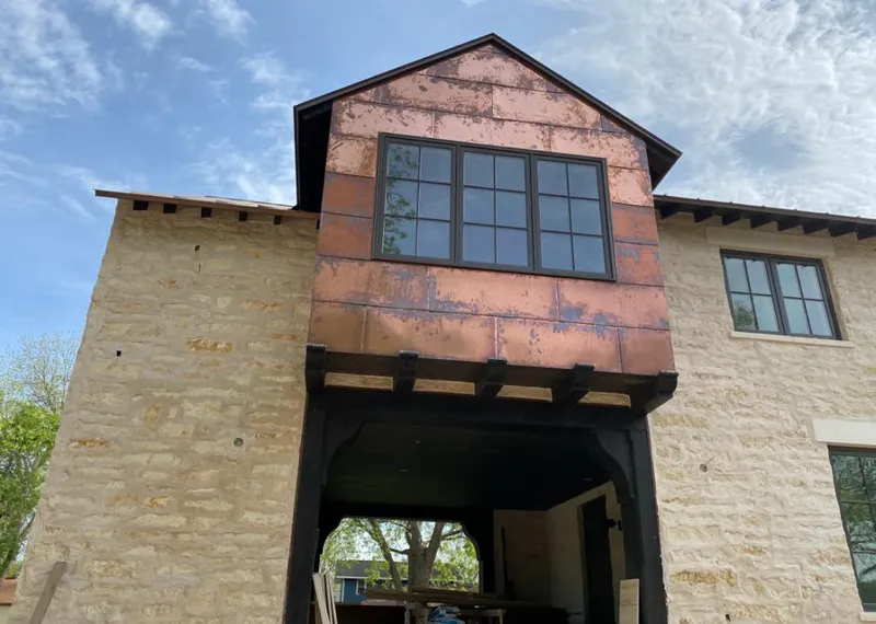 Copper metal panel facade on a stone building for Roof Repair in Paradise Valley