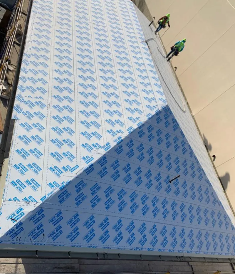 Professional roofers installing underlayment on a metal roof in Paradise Valley